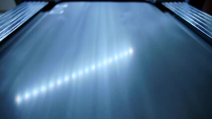 Metallic surface reflecting light with a pattern of bright spots