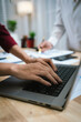 © Worawi - A corporate team collaborates in an office, analyzing financial reports and charts. They discuss strategy, investment, and planning to achieve growth, innovation, success, and long-term business perfo
