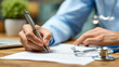 © venusvi - A healthcare professional writes in a notebook, capturing important patient information with a stethoscope nearby.