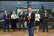 © Studio Romantic - Team of corporate workers in formal clothing standing and clapping hands, meeting new colleague, thanking for good business presentation. Company employees team or group of staff celebrating success