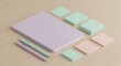 © Kraitong - Stylish pastel stationery with notebook and sticky notes on wooden surface