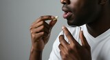 African American Man Taking Medication with a Glass of Water