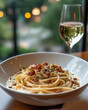 © Illustratorstock - Photograph of spaghetti carbonara served in a white ceramic bowl. The creamy sauce coats the pasta, with crispy pancetta and a sprinkling of black pepper on top.