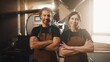 © VAKSMANV - Caucasian man with and woman standing with crossed arms. Looking directly at camera while smiling positively. Confidently posing together in bright coffee roasting facility. Teamwork.