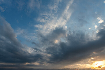 Wall Mural - Evening sunset sky background with bright dramatic clouds.