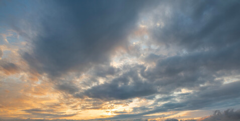 Wall Mural - Evening sunset sky background with bright dramatic clouds.