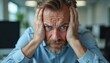 © Vadym - Finance consultant, overwhelmed by stress, fatigue, holds head in hands in office. Shows frustration, anxiety from workplace pressure. Focuses on pro burnout, mental health, productivity challenges.