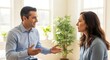 © Mey - A man and a woman in a conversation, with a plant in the background.