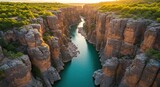 Deep gorge carved by a blue river, flanked by steep cliffs and lush greenery at golden hour