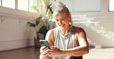 Phone, smile and old woman in studio for fitness, exercise schedule or information online for health. Mobile, gym or happy senior person check wellness app for pilates, track progress or retirement