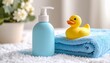 © Sherna - Baby Bath Concept with Blue Towel, Rubber Duck, and Pump Bottle