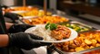 © Asif - catering buffet dinner, Canteen worker plates food at buffet. Variety of dishes potatoes, couscous, meat. Service line, food preparation. Restaurant setting, catering service. Lunch dinner time. Perso
