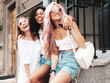© halayalex - Three young beautiful smiling female in trendy summer clothes.Sexy carefree multiracial women posing on the street background.Positive models having fun in sunglasses. Cheerful and happy
