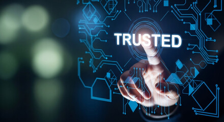 Finger presses the word trusted on a futuristic glowing digital interface