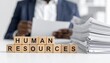© photostockatinat - Human resources concept: Focused on human resources with papers in front of a person