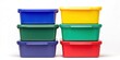 © Creations Photo  - A stack of six colorful plastic storage containers is arranged against a black background. The containers are stacked in a pyramid formation, with the largest container at the bottom and the smallest