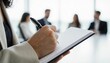 © Lightning - Focused professional taking notes in a meeting – capturing important information