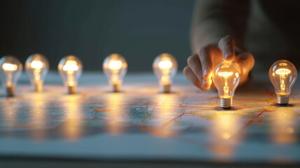 Wall Mural - hand places glowing light bulb on map, symbolizing ideas and innovation. scene conveys creativity an