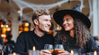 © dinatychynska - Halloween couple toasting with drinks at cozy cafe during festive party. Young people celebrating seasonal date night in witch hat costume with warm bokeh lights background at restaurant bar.