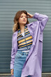 © LIGHTFIELD STUDIOS - A young woman with a charming expression poses in a stylish outfit, exuding confidence and joy