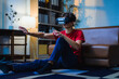 © PaeGAG - Teenager experiencing virtual reality using headset, interacting with digital environment in home setting
