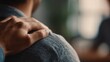 © Justlight - Medium shot of a supportive hand on a friends shoulder softly outoffocus group setting conveying compassion connection and peer support in mental health.