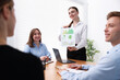 © New Africa - Business coach giving presentation to group of people in office