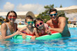 © New Africa - Happy family in swimming pool. Summer vacation