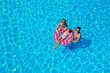 © New Africa - Happy family with inflatable ring in swimming pool. Summer vacation