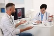 © New Africa - Man having appointment with gastroenterologist in clinic