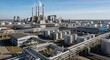 © Anik Sarker - Expansive industrial complex with towering smokestacks under a clear blue sky symbolizing modern manufacturing and energy production
