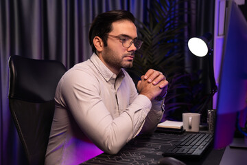 Working smart IT developer analyzing data software development on two pc screen, creating application program updated version online website page system online at neon light cyber office. Surmise.