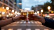 © Dream Studio - Cheers: Two Hands Toasting Beer at Dusk in City Street, Warm Golden Hour Light
