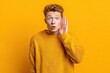 © LimeSky - Attractive young white man alone attempting to hear gossip
