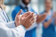 © LimeSky - Closeup of healthcare workers celebrating success with a handshake during a hospital meeting