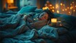 © Supatip - A woman is peacefully asleep in a cozy bed, creating a scene of comfort and tranquility. The soft glow of candlelight and fairy lights adds a warm and inviting atmosphere.