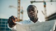 © akridiy - Black Architect Reviewing Blueprints at Construction Site