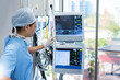 © wavebreak3 - Nurse monitoring patient vital signs on dual screens beside large window in hospital room