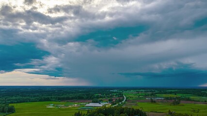 Wall Mural - Dramatic storm cloud formation over rural farmland in aerial hyperlapse during summer