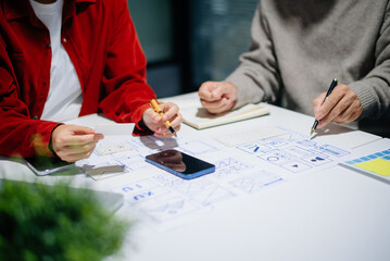 Wall Mural - UX graphic designer planning application process development prototype wireframe for web smart phone. Creative digital development agency.