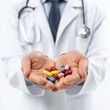 © Laslo - Doctor holding pills in hand, isolated on white background