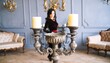 © Yogi - Woman in velvet dress, antique candelabra, elegant interior