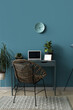 © Pixel-Shot - Modern workplace with laptop and houseplants near blue wall in office