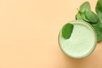 Wall Mural - Glass of fresh spinach smoothie on yellow background