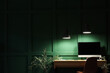 © Pixel-Shot - Stylish workplace with modern computer near green wall in office at night