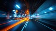 © IKM - The dynamic motion of cars racing through a lit urban tunnel at night