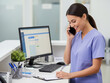 © Alingga - Woman in medical uniform is receiving a call at desk.