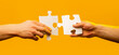 © Yevhen - Hands connecting puzzle pieces. Male and female hand joining two matching puzzle pieces together in a conceptual image of teamwork and cooperation