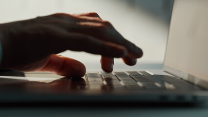 Wall Mural - Businessman hands writing email on laptop at corporate office space closeup