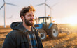 ©  Studio AB Images - Caucasian ethnicity adult male farmer on field with farm tractor and wind energy turbines in background